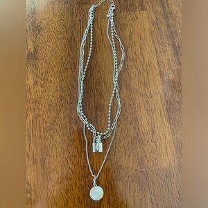 Layered necklaces in gold tones